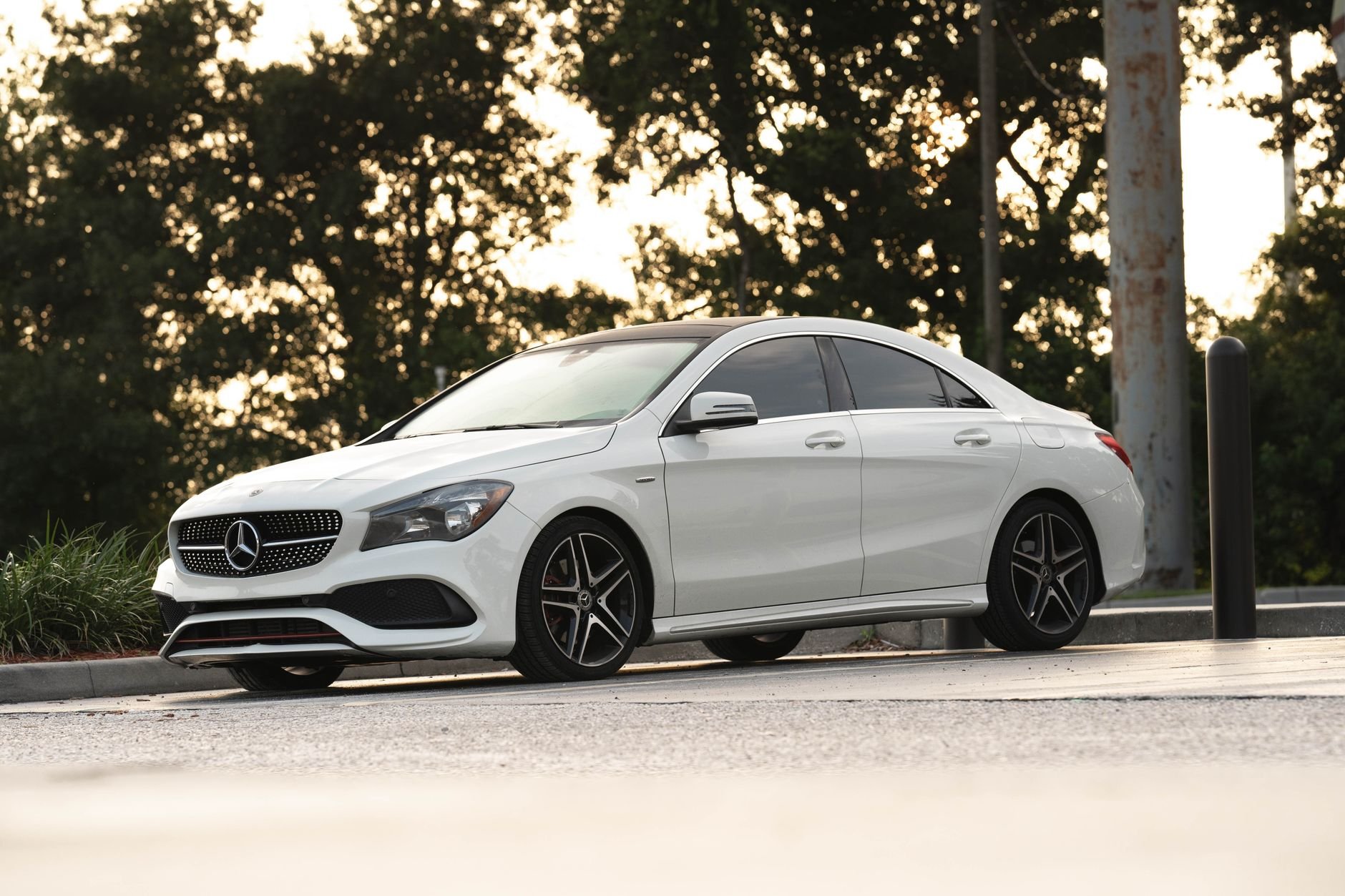 A stylish white luxury sedan parked outdoors in Florida sunlight